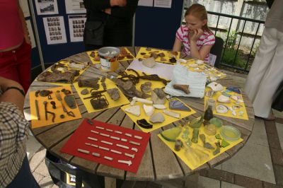 02MG03_001
A collection of "finds" made during the building of the garden were on display at the official opening on 20th May 2007. These were all cleaned and sorted by Graham and Denise Hayward with their daughters Zara, Megan & Chloe. The picture shows Zara with the display. 

By Tony Morris
