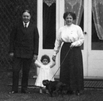 04TM03_05_08_16
Katie's mother and father with Mary and their pet black pug dog. Black pugs have been Katie's lifelong favourite dog 

From Katie Burmester
