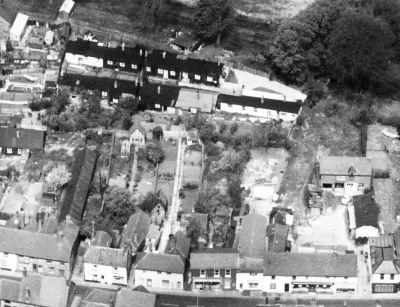 05_2BSCT_001
This aerial photo was taken in about 1964. In the top part of the picture can be seen a collection of ex WW1 Canadian Army huts. These are believed to have been built in the 1920s as temporary accommodation for mill workers and were subsequently sold off to villagers. Little information is available about this little development of nine(?) dwellings but they became known as Chinatown, probably because of their ramshackle appearance.
