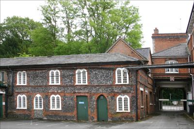 09PO006_2
This is the oldest remaining part of Laverstoke Mill and is the setting for the previous picture. This building, originally workers' cottages, stands beside the main gate. There were no stairs so the upper rooms were reached by ladders. Photographed 2006. 

By Tony Morris
