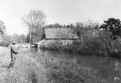 12TT027_01
Brigadier-General Sir Birtram Portal fishing downstream of the bridge in Bridge Street c.1916. NB this was before the footbridge was added and the thatched cottage has since been demolished. 

From David Bishop
