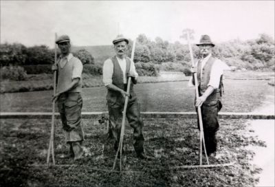 11TO023_1
Working on the Polhampton watercress beds - from the left - Edward Smith, Walter Dawe and Joe Dawe. This was one of several watercress beds on the Test near Overton and cress used to be delivered daily by train to Covent Garden Market in London. Rising costs and static prices made the crop uneconomic and the beds fell into disuse in about the 1950s 

From Christine Shaughnessy nee Smith
