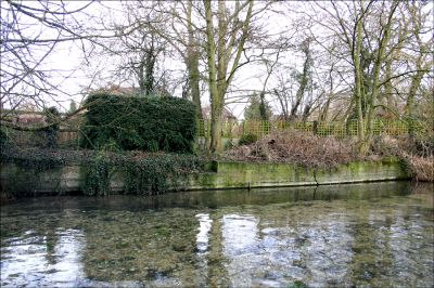 12TT011_2
This photograph was taken in 2006 wearing wellington boots. It shows all that remains of the old pool where the children used to dive in when the water was much deeper. The pool was closed in c.1950 because of the risks of polio 

By Tony Morris
