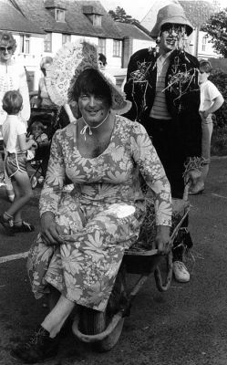 15_1OC002_03_01
This photo shows Denny McCann and Nigel Williams - in the wheelbarrow race c.1981. The baby in the pram is Laura, Janice's daughter 

Photo from Janice Stott
